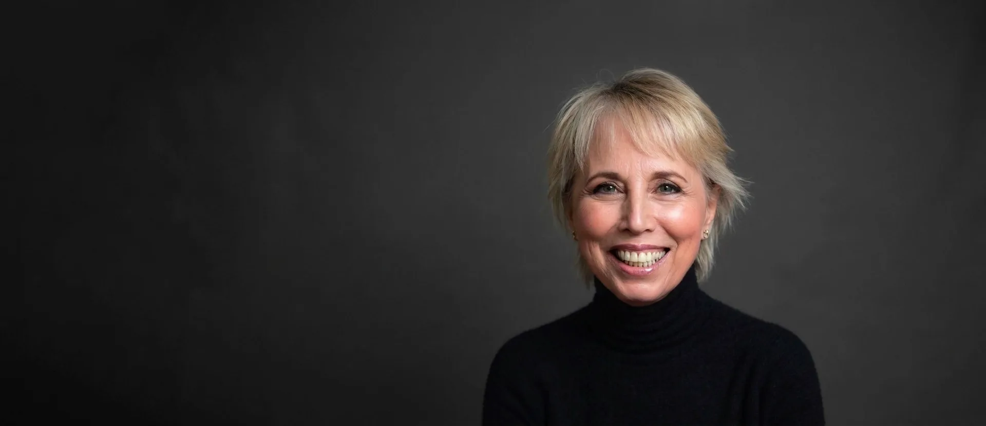 Geneen Roth smiling, in a black turtleneck